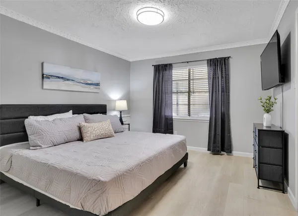 a bedroom with a bed and tv