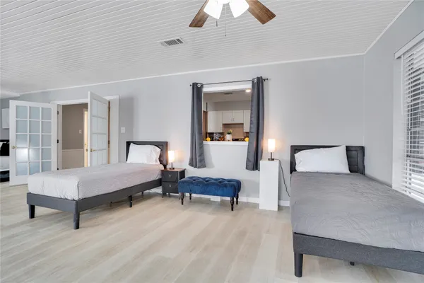 a bedroom with a bed and a chandelier