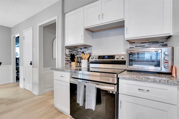 a kitchen with appliances cabinets and a counter top space