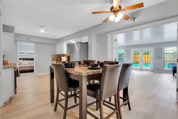 a view of a a dining room with furniture window and wooden floor