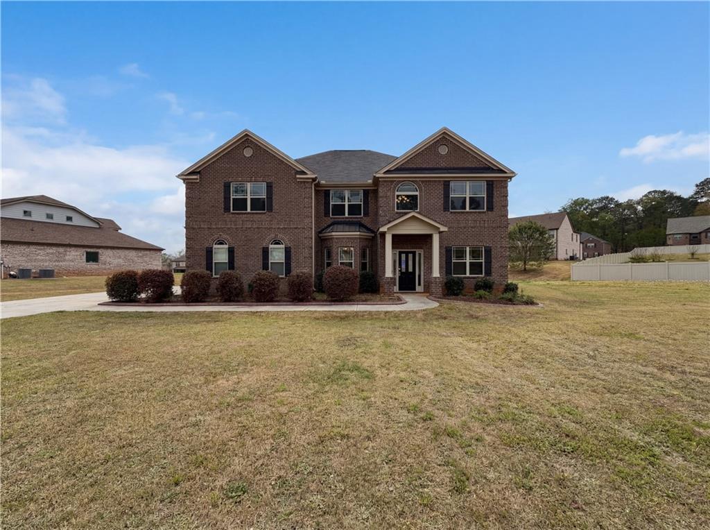 1549 Harlequin Way Stockbridge, GA 30281 - Photo 1 of 30 a front view of a house with a yard