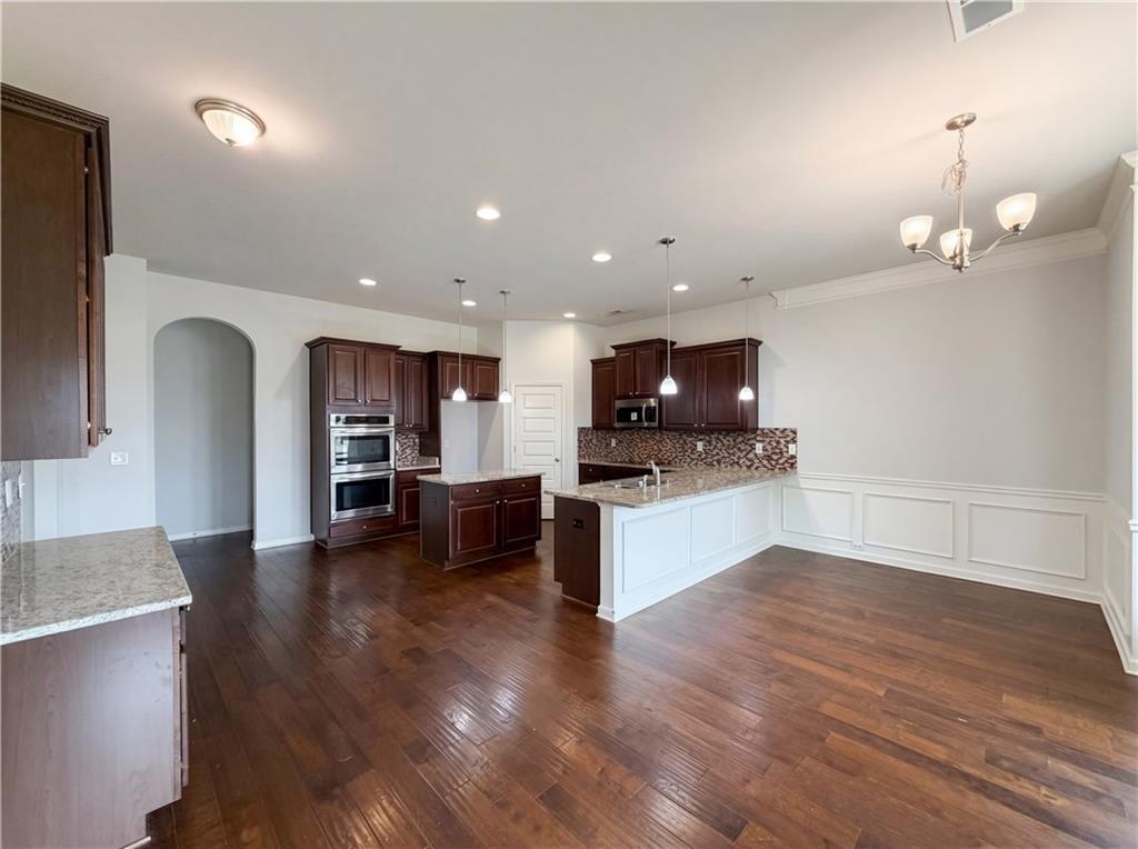 1549 Harlequin Way Stockbridge, GA 30281 - Photo 11 of 30 a view of kitchen with sink microwave and refrigerator