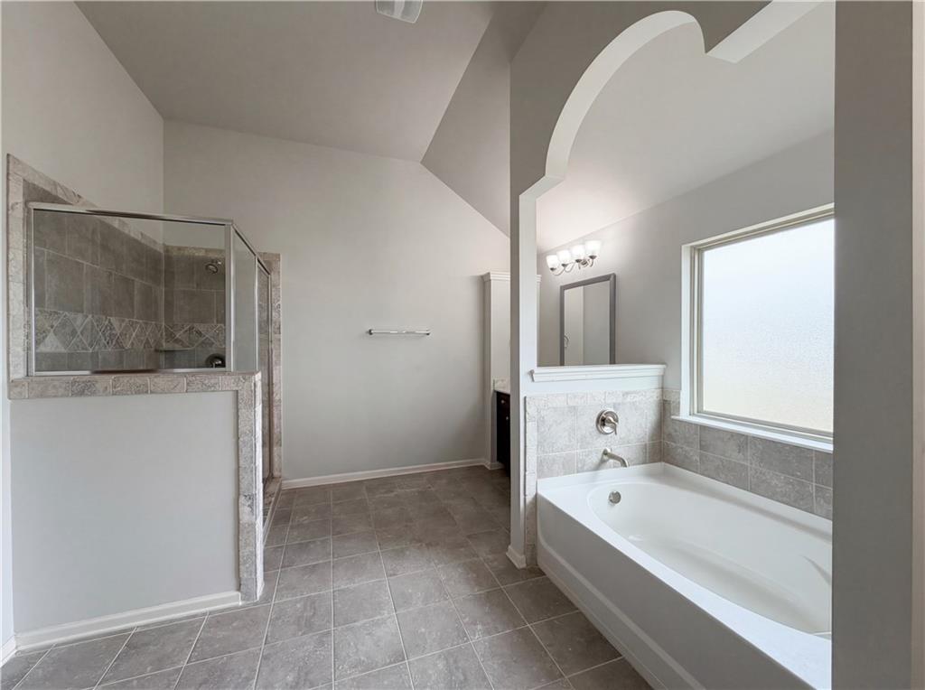 1549 Harlequin Way Stockbridge, GA 30281 - Photo 17 of 30 a bathroom with a bathtub and a bathroom