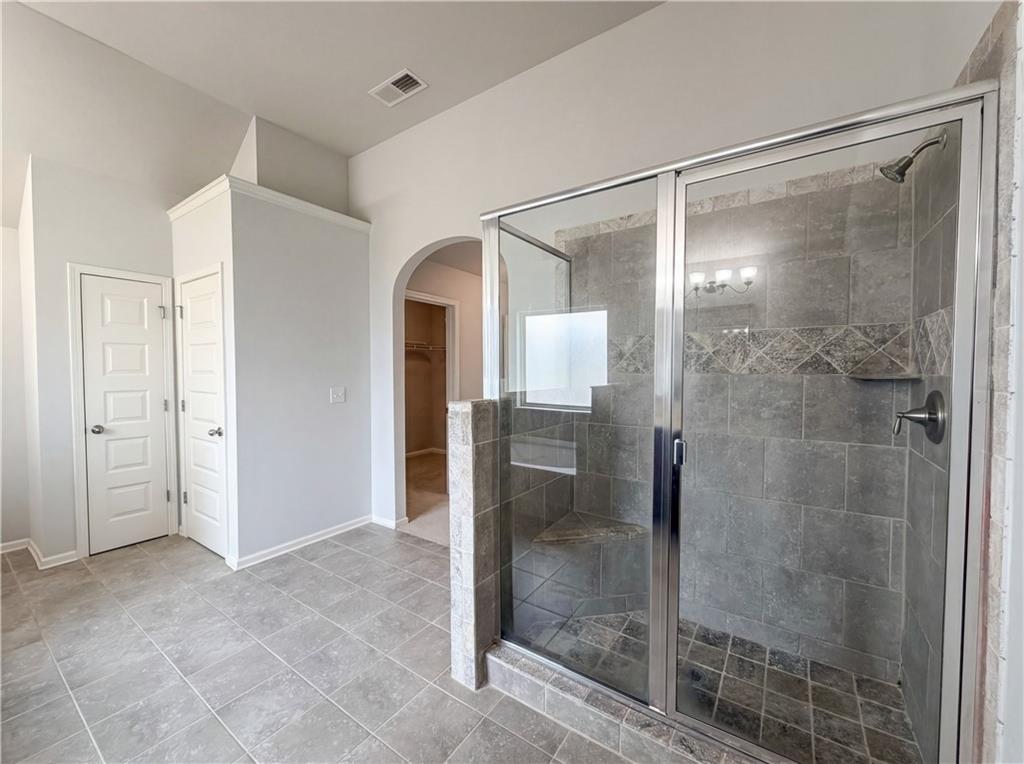 1549 Harlequin Way Stockbridge, GA 30281 - Photo 19 of 30 a bathroom with a glass shower door