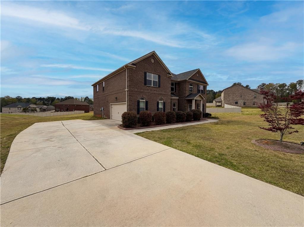 1549 Harlequin Way Stockbridge, GA 30281 - Photo 2 of 30 a view of a house with a yard