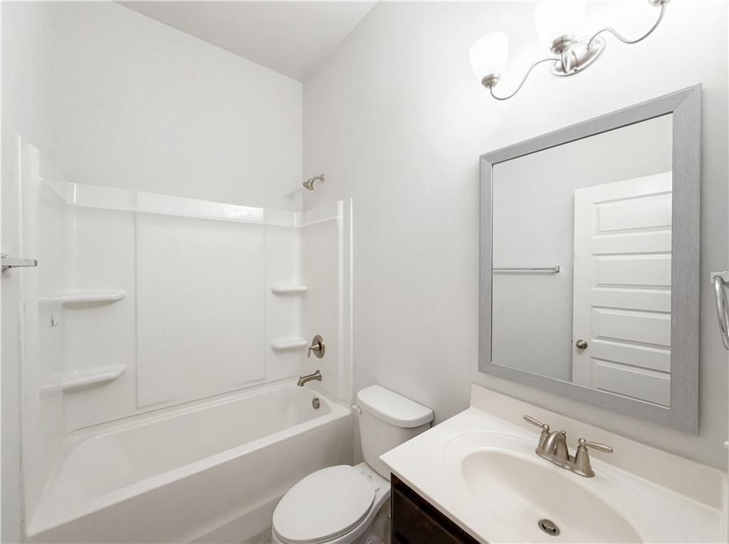 1549 Harlequin Way Stockbridge, GA 30281 - Photo 24 of 30 a bathroom with a sink toilet and shower