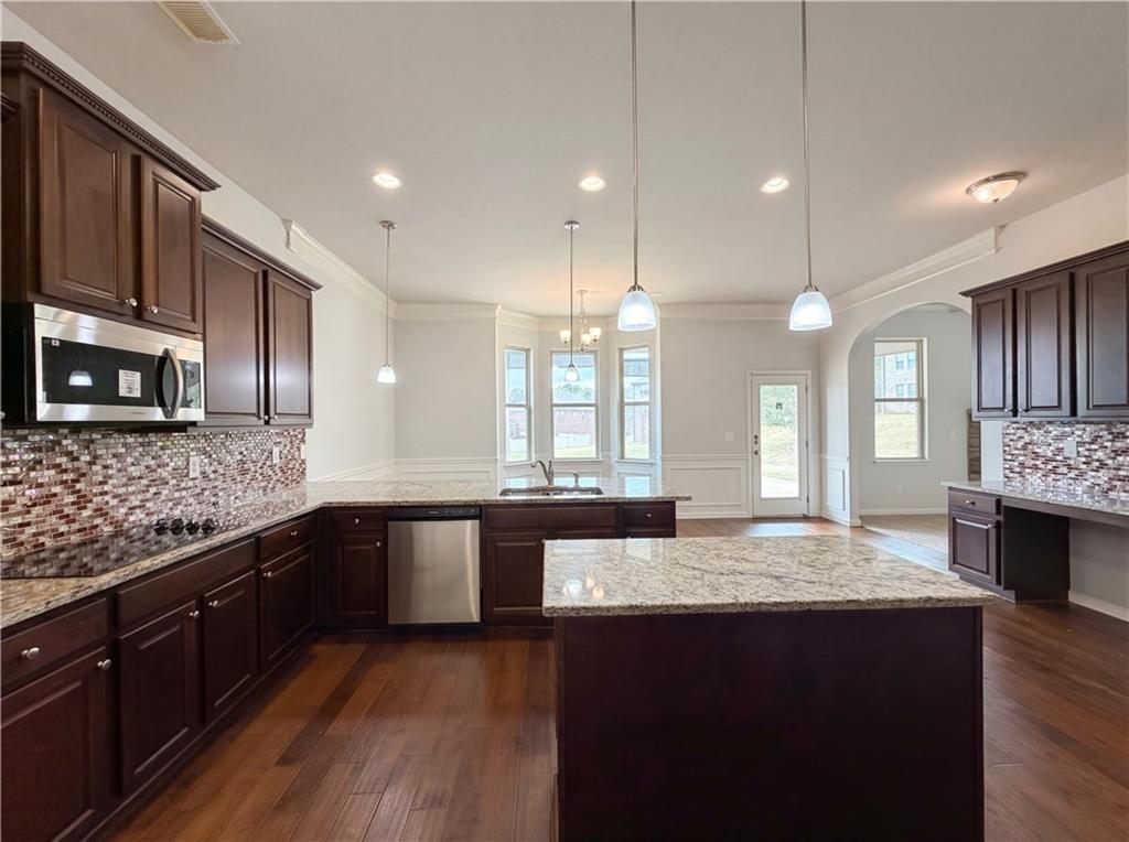 1549 Harlequin Way Stockbridge, GA 30281 - Photo 10 of 30 a large kitchen with granite countertop a lot of counter space and wooden floor