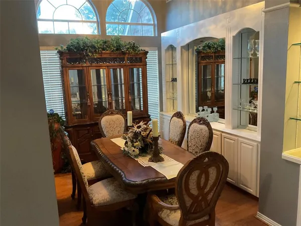 a view of a dining room with furniture and chandelier