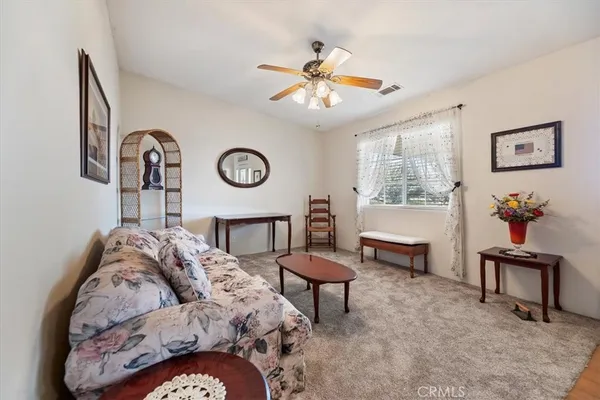 a living room with furniture and a clock