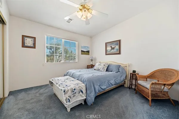 a bathroom with a granite countertop sink mirror and toilet