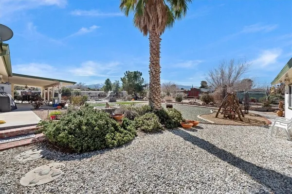 a backyard of a house with barbeque oven fire pit table and chairs
