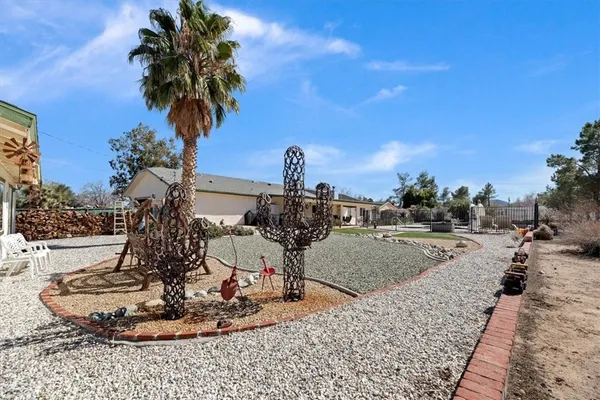 a view of dirt road with a building
