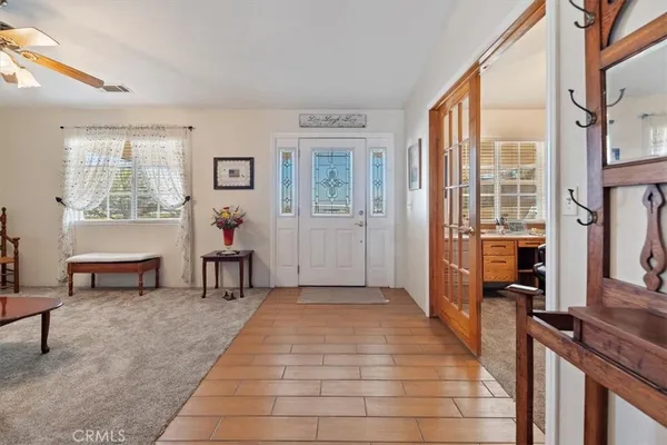 a living room with furniture a chandelier and a window
