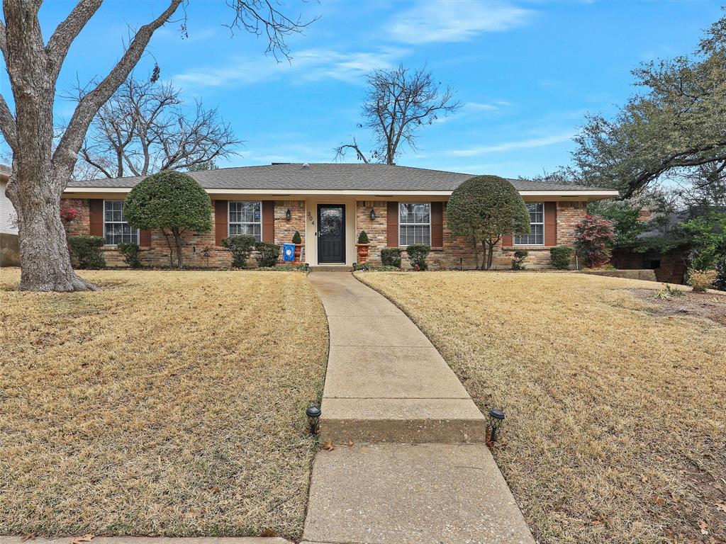 304 Ridgewood Drive Richardson, TX 75080 - Photo 1 of 1 a front view of a house with a yard