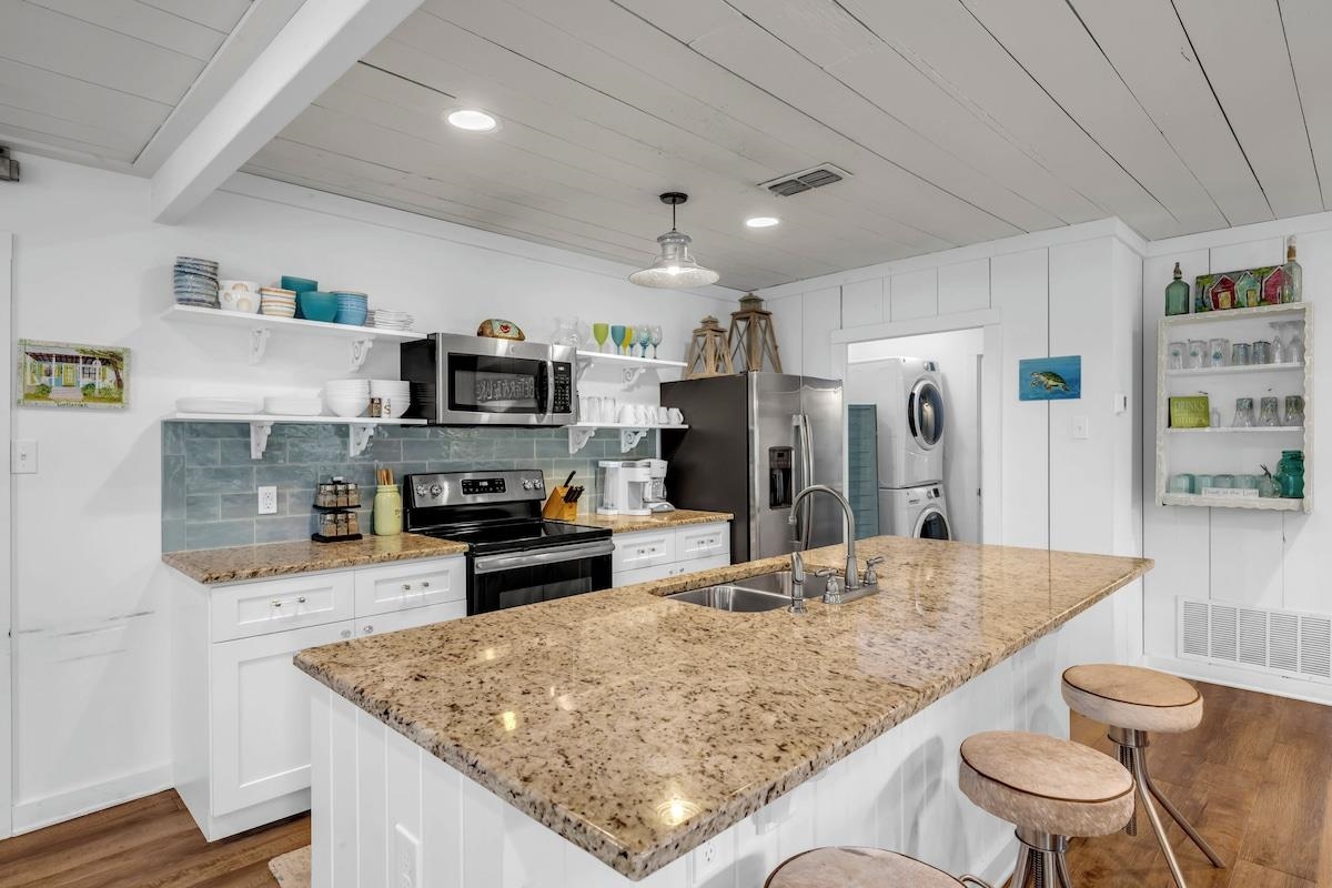 200 Highland Loop Kingsland, TX 78639 - Photo 2 of 23 a kitchen with stainless steel appliances granite countertop a sink stove and refrigerator