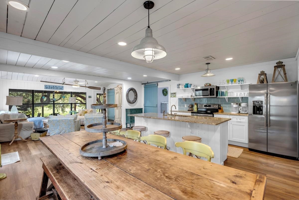 200 Highland Loop Kingsland, TX 78639 - Photo 4 of 23 a kitchen with stainless steel appliances granite countertop a sink counter space and living room view