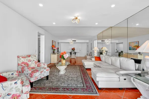 a kitchen with stainless steel appliances granite countertop a refrigerator a stove top oven a sink dishwasher and white cabinets