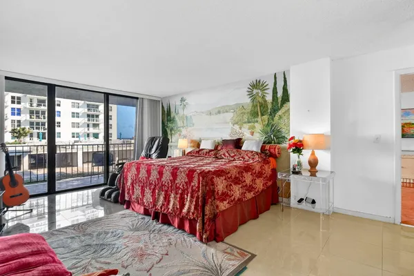 a bedroom with a bed window and flat screen tv