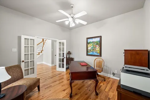 a bedroom with a bed and wooden floor