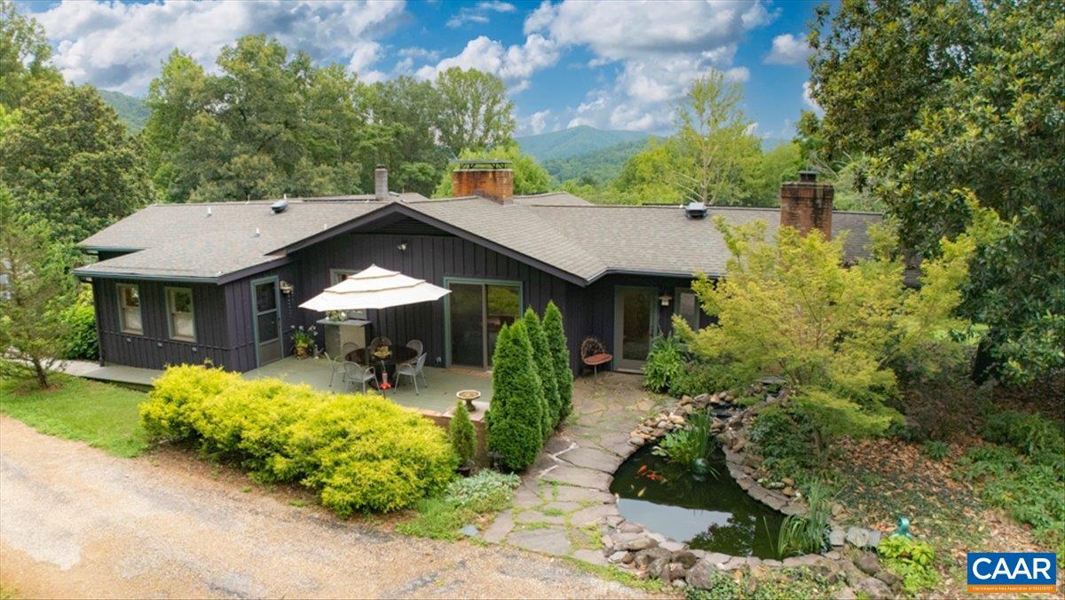 a front view of a house with a yard table and chairs