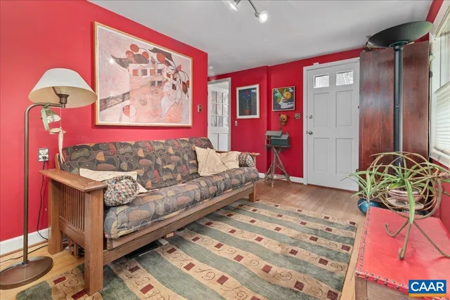 a living room with furniture a rug and a bookshelf