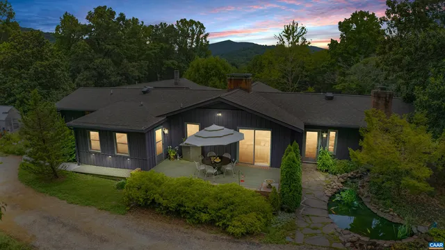 a front view of a house with a yard with potted plants