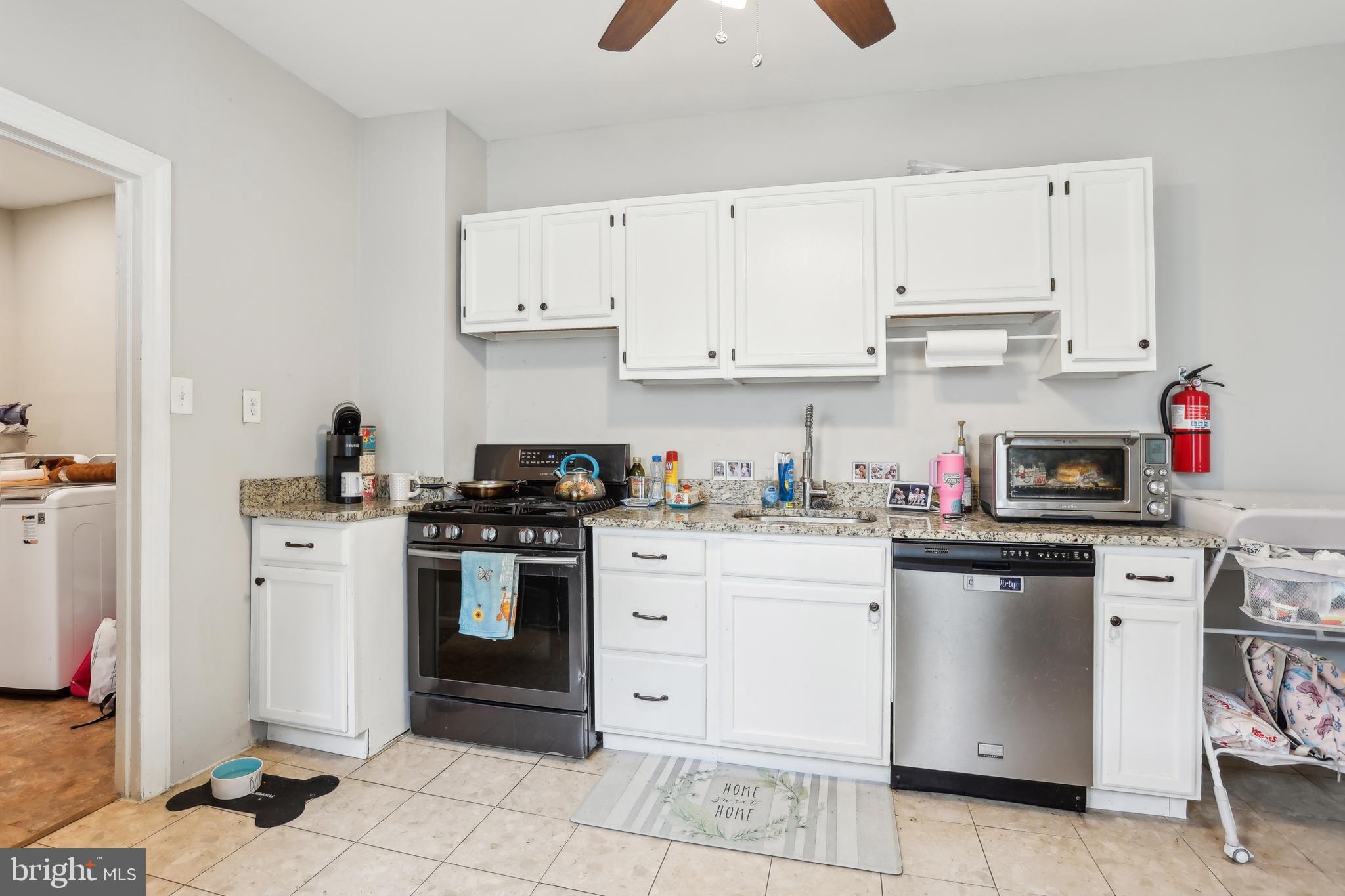 705 Burlington Avenue Delanco, NJ 08075 - Photo 13 of 41 a kitchen with stainless steel appliances granite countertop a stove and white cabinets