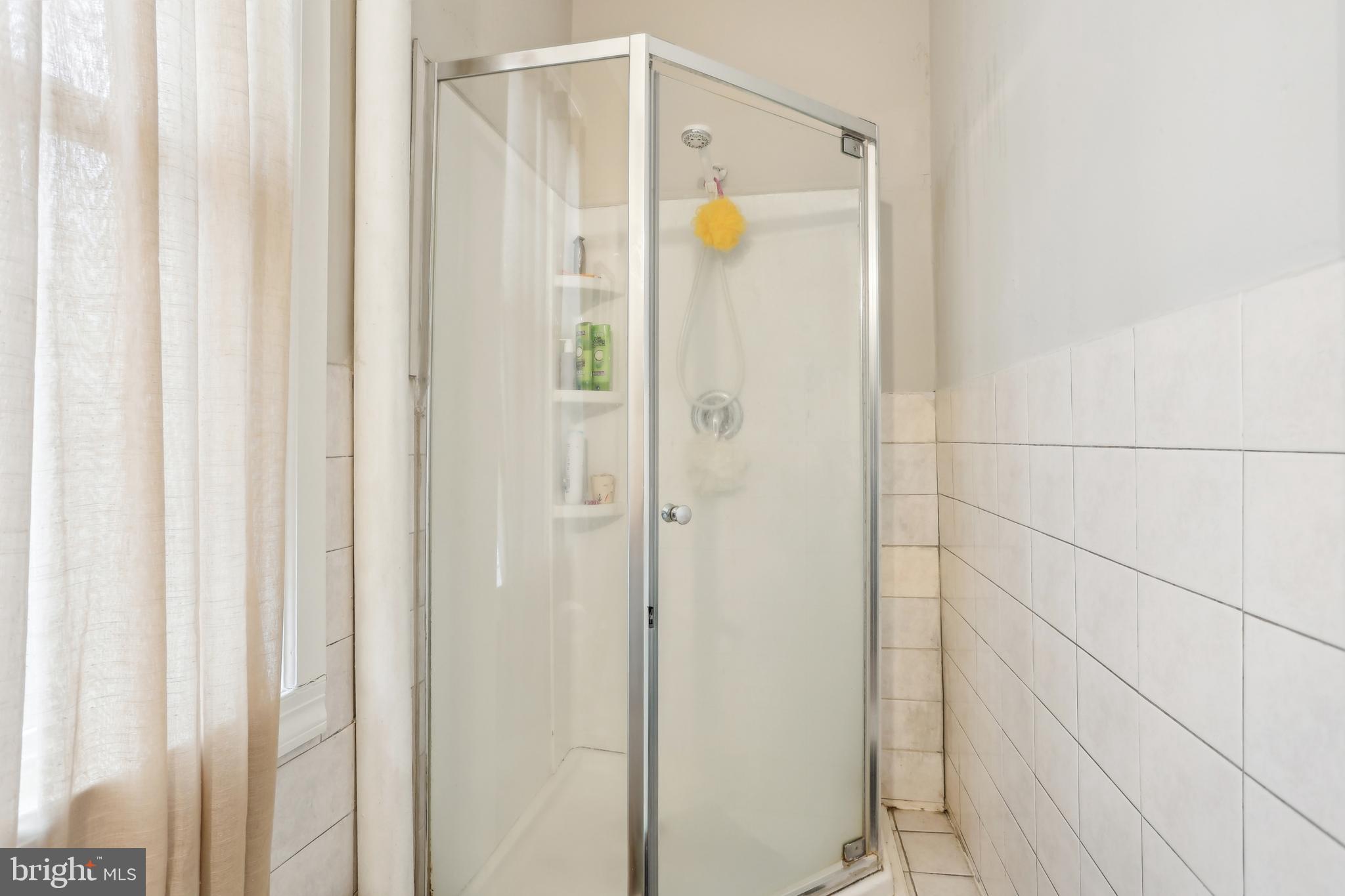 705 Burlington Avenue Delanco, NJ 08075 - Photo 15 of 41 a bathroom with a glass shower door and a shower curtain