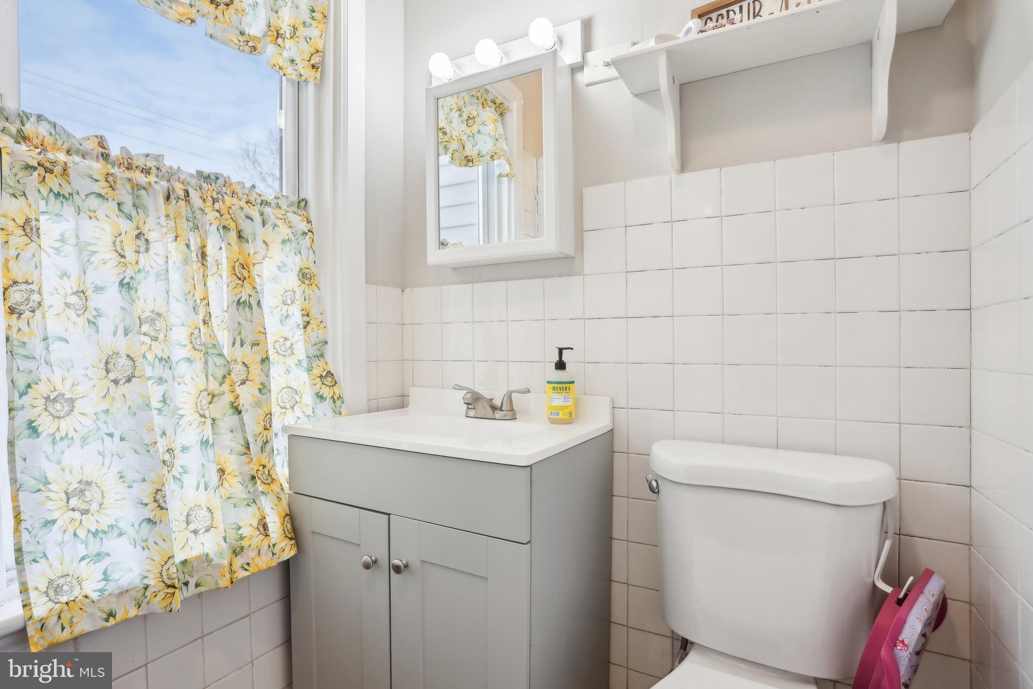 705 Burlington Avenue Delanco, NJ 08075 - Photo 23 of 41 a bathroom with a sink a toilet and a shower curtain