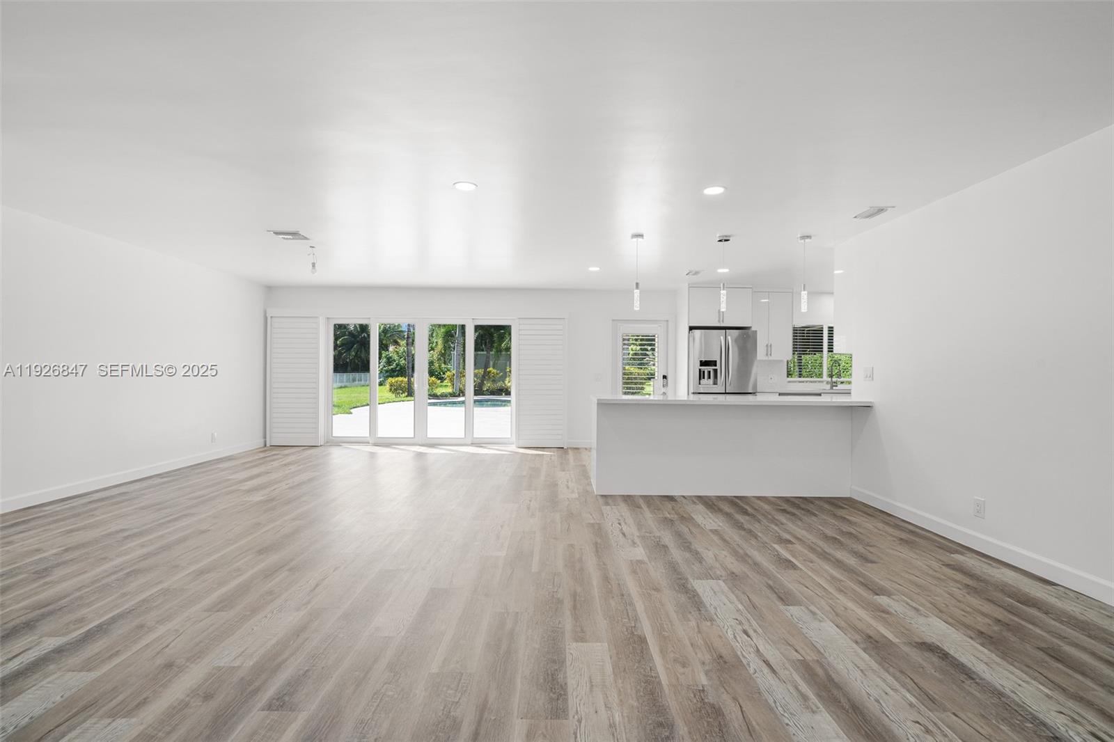 14330 Southwest 16th Street Davie, FL 33325 - Photo 12 of 53 wooden floor in an empty room with a window