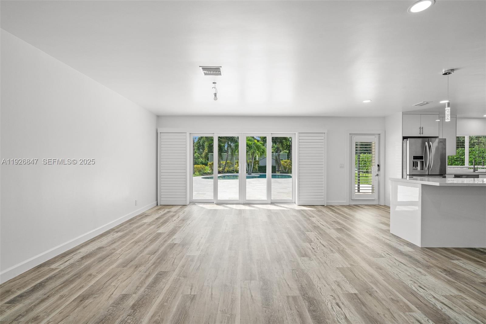 14330 Southwest 16th Street Davie, FL 33325 - Photo 14 of 53 a view of an empty room with wooden floor and a window