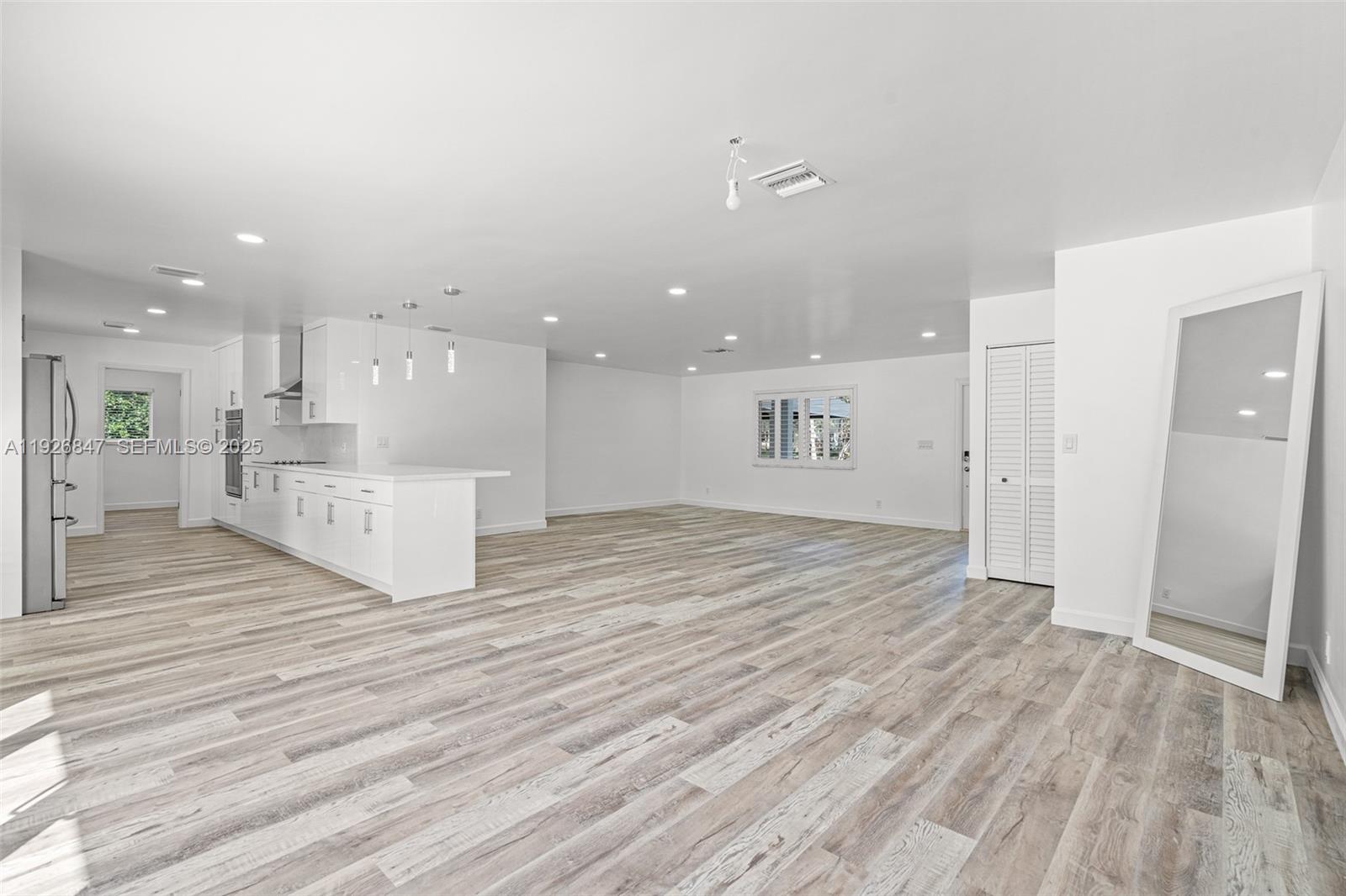 14330 Southwest 16th Street Davie, FL 33325 - Photo 15 of 53 a view of a kitchen with white cabinets and wooden floor