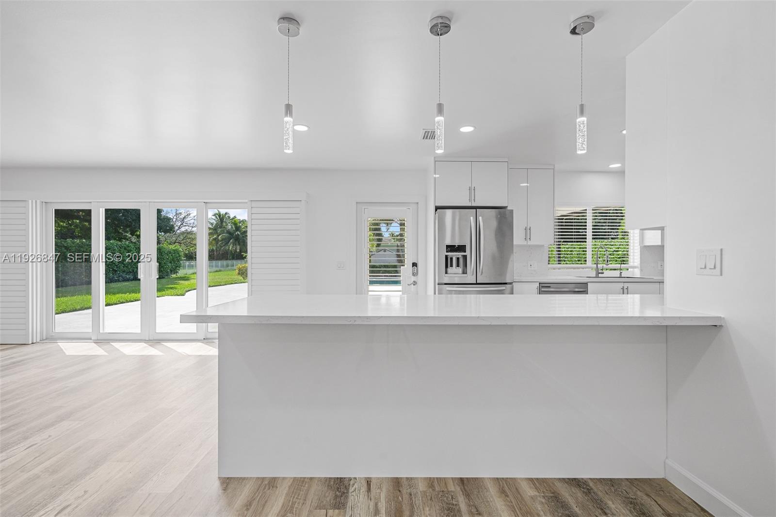 14330 Southwest 16th Street Davie, FL 33325 - Photo 17 of 53 a large kitchen with kitchen island a large window and stainless steel appliances