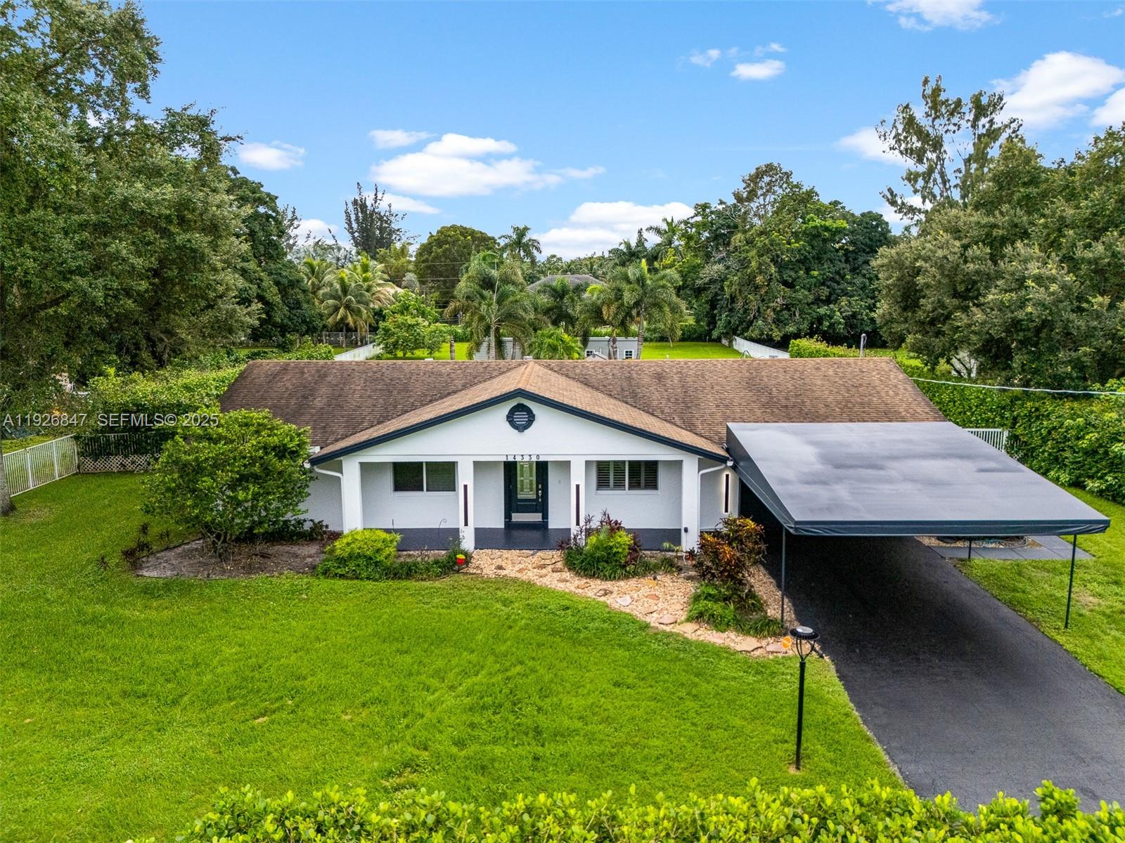14330 Southwest 16th Street Davie, FL 33325 - Photo 2 of 53 a aerial view of a house with a yard table and chairs