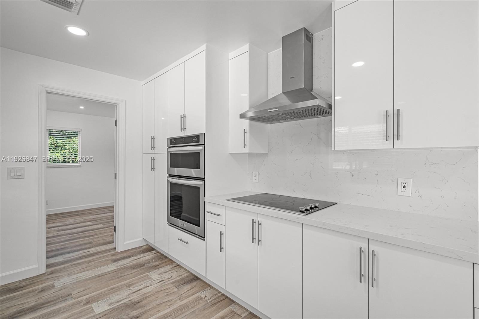 14330 Southwest 16th Street Davie, FL 33325 - Photo 21 of 53 a kitchen with stainless steel appliances granite countertop a stove and a refrigerator