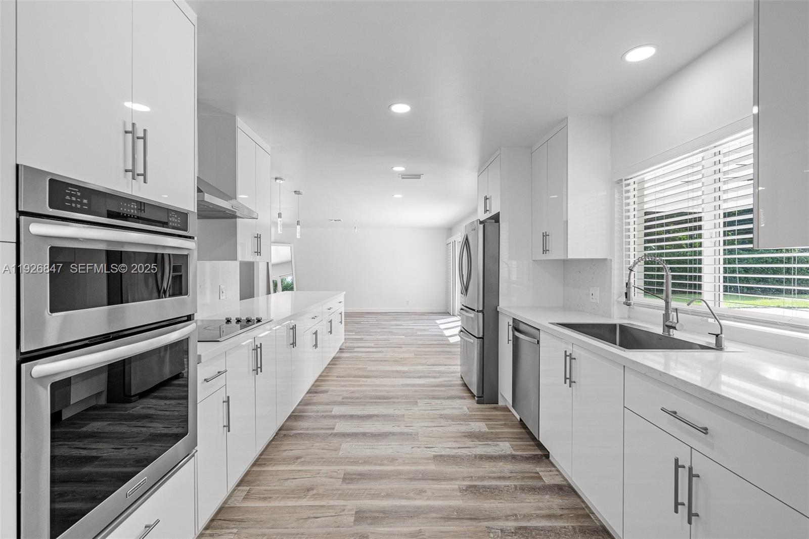 14330 Southwest 16th Street Davie, FL 33325 - Photo 22 of 53 a kitchen with stainless steel appliances a stove sink and cabinets