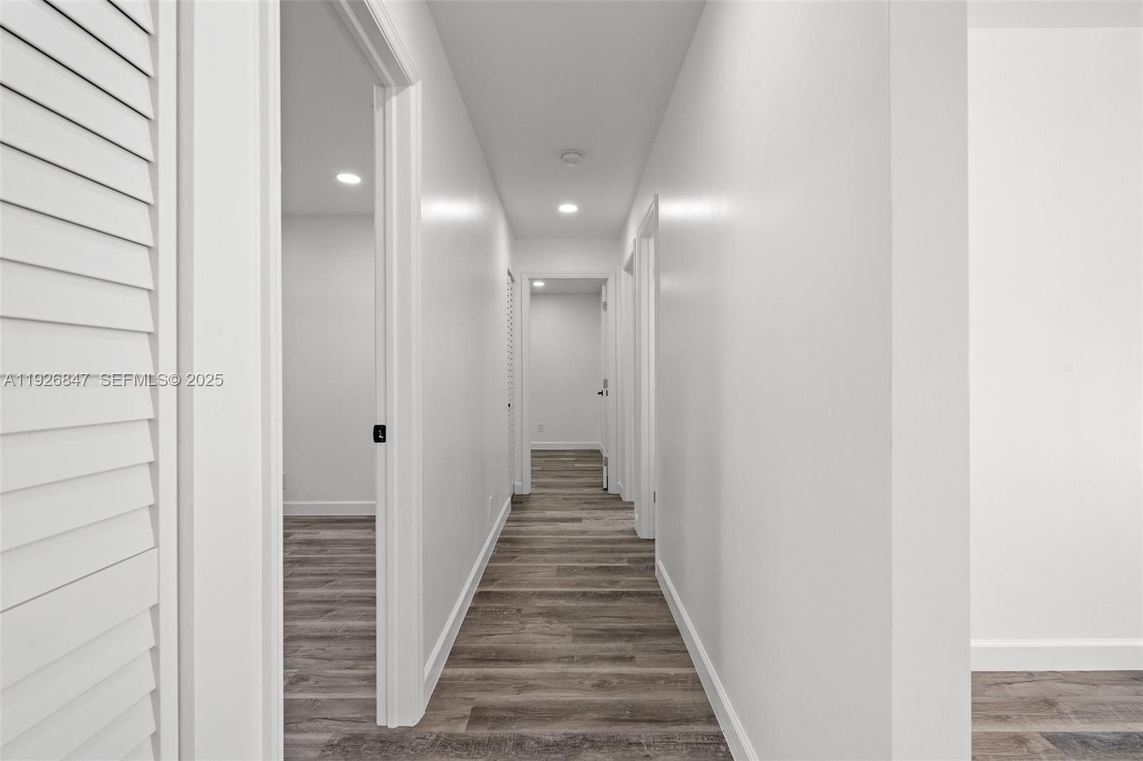 14330 Southwest 16th Street Davie, FL 33325 - Photo 24 of 53 a view of a hallway with wooden floor and a bathroom