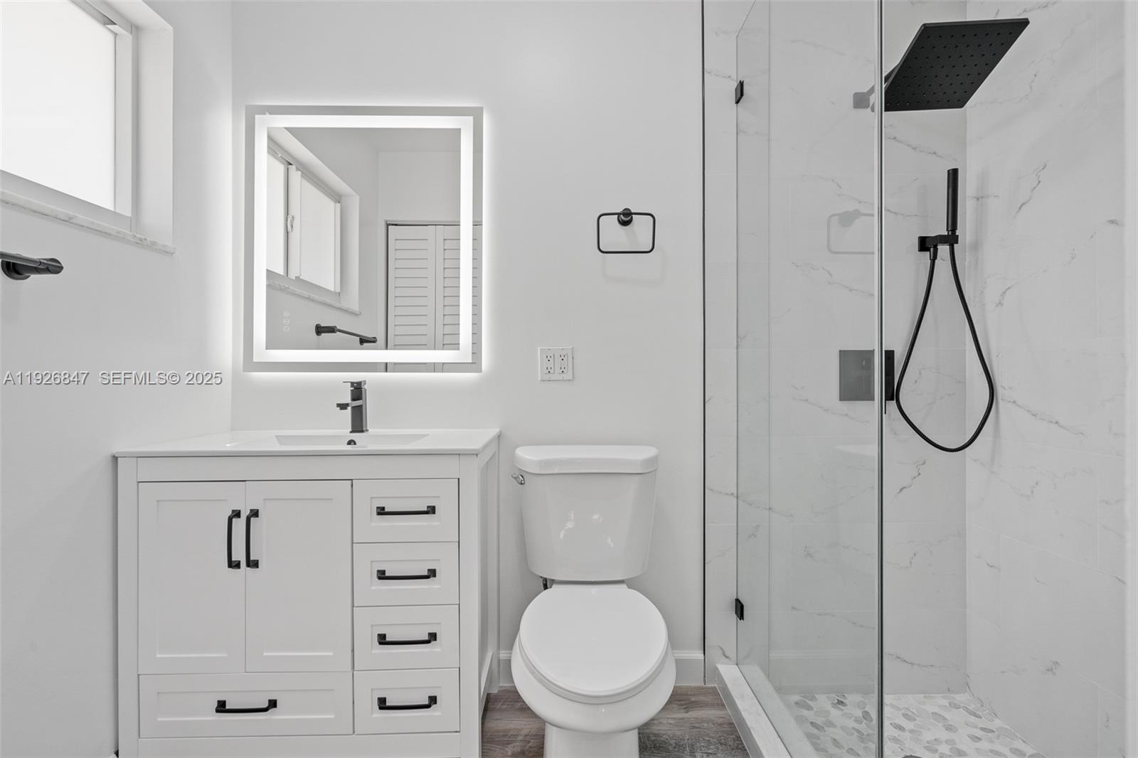 14330 Southwest 16th Street Davie, FL 33325 - Photo 28 of 53 a bathroom with a toilet a sink a mirror and vanity