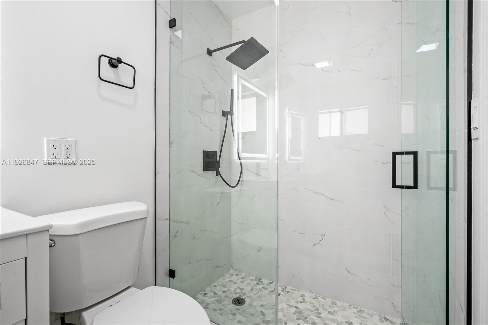 14330 Southwest 16th Street Davie, FL 33325 - Photo 29 of 53 a bathroom with a shower a toilet and a sink