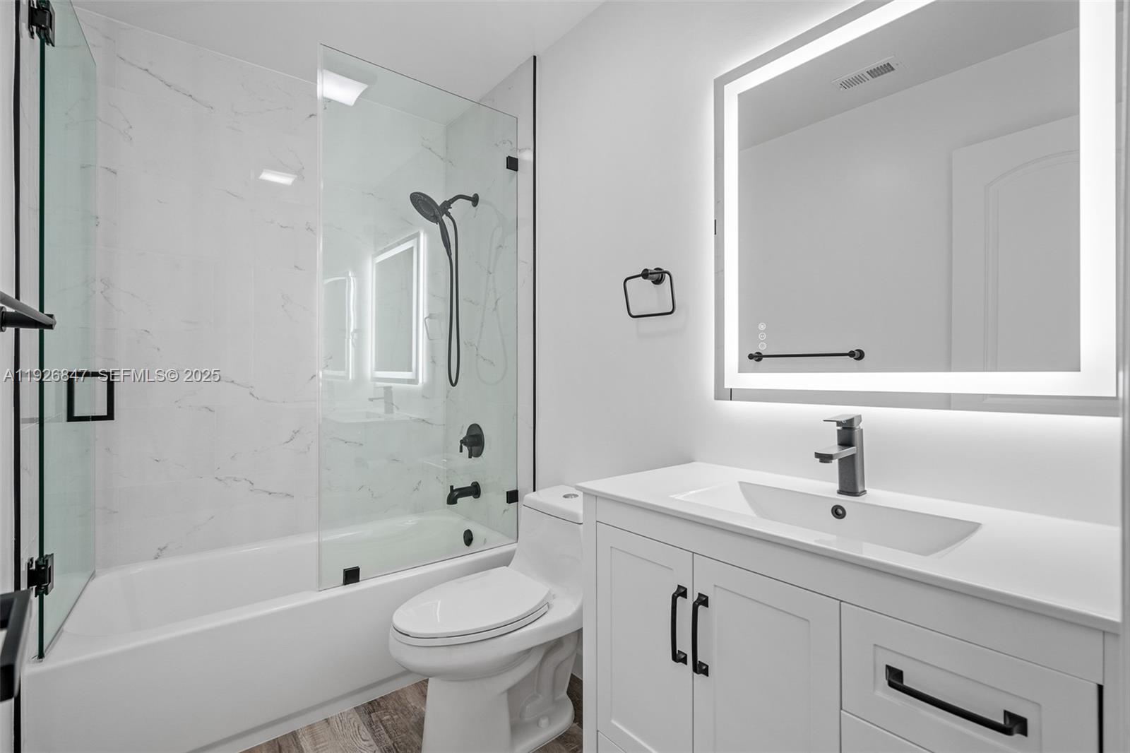 14330 Southwest 16th Street Davie, FL 33325 - Photo 32 of 53 a bathroom with a sink a toilet and shower