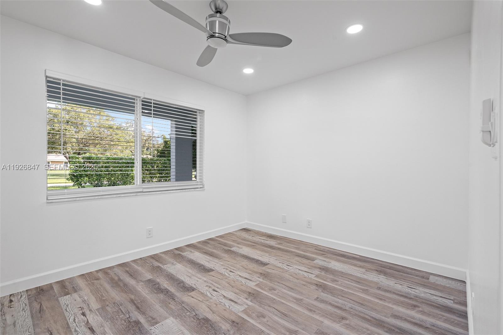 14330 Southwest 16th Street Davie, FL 33325 - Photo 33 of 53 an empty room with a window and ceiling fan