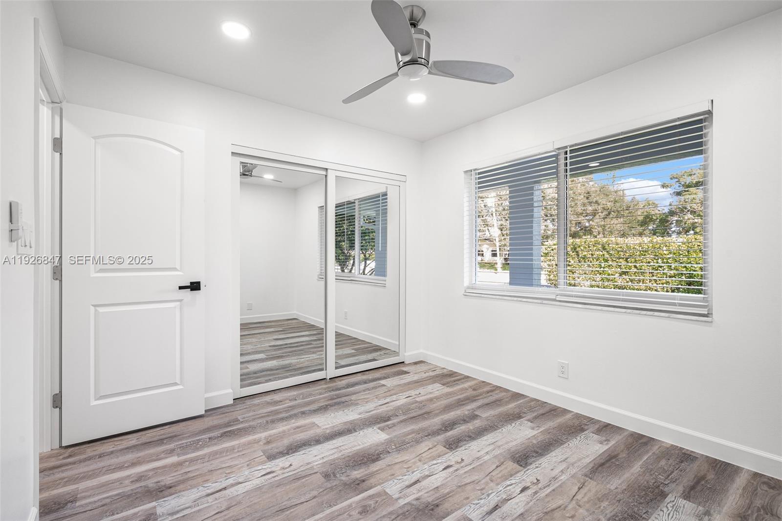 14330 Southwest 16th Street Davie, FL 33325 - Photo 34 of 53 an empty room with wooden floor cabinet and windows