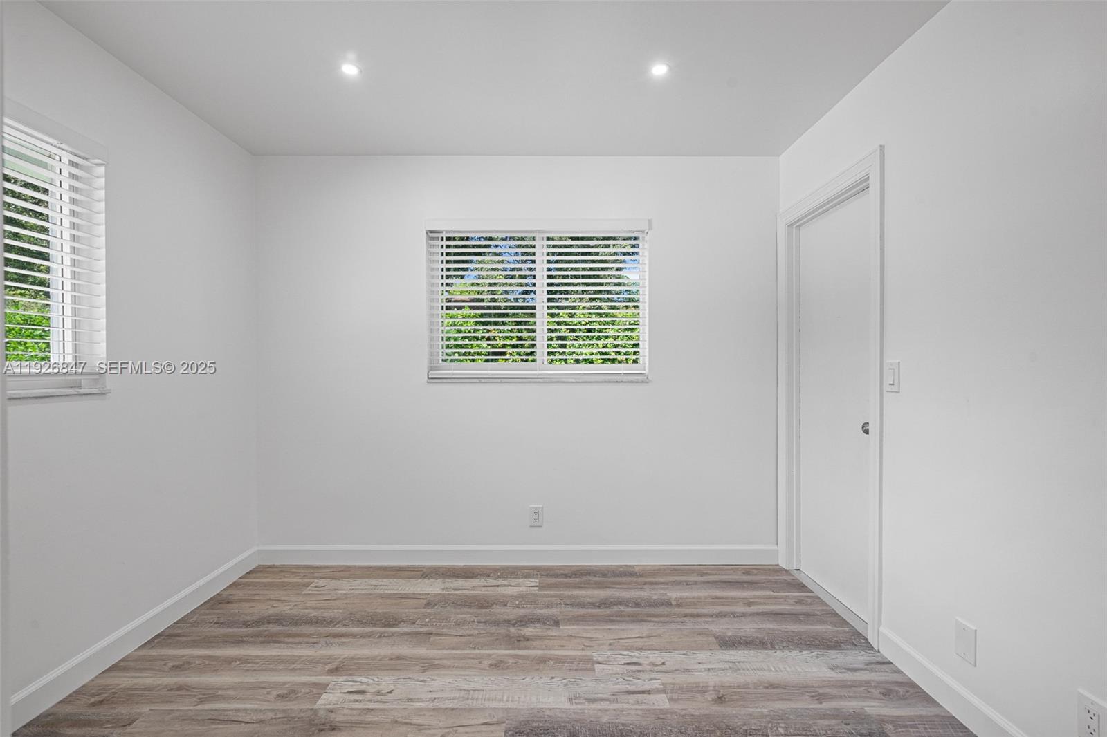14330 Southwest 16th Street Davie, FL 33325 - Photo 35 of 53 an empty room with wooden floor and windows