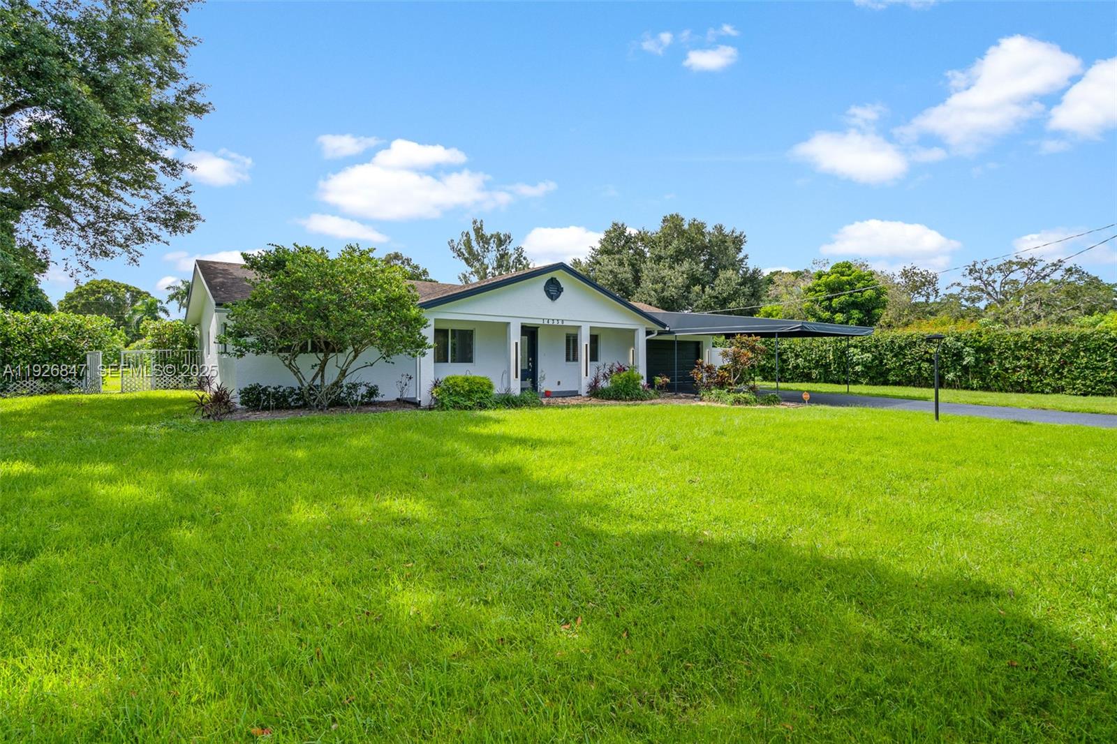 14330 Southwest 16th Street Davie, FL 33325 - Photo 4 of 53 a front view of house with yard and green space