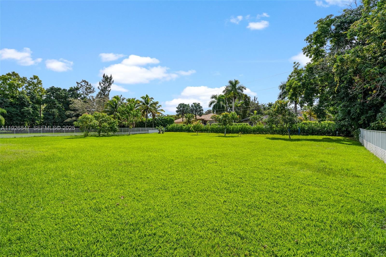 14330 Southwest 16th Street Davie, FL 33325 - Photo 45 of 53 a view of a green field with wooden fence