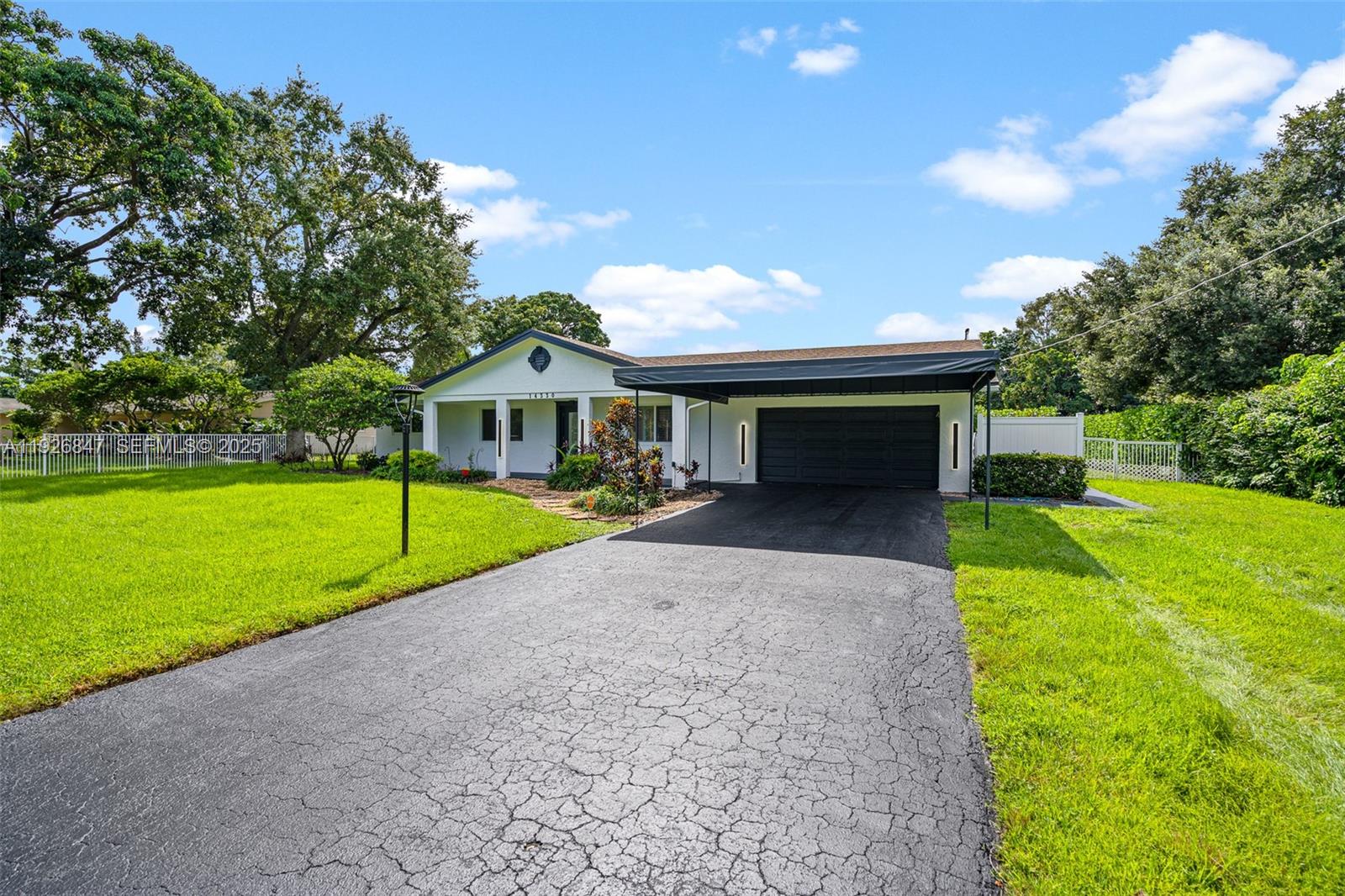 14330 Southwest 16th Street Davie, FL 33325 - Photo 5 of 53 a view of a house with a yard and a patio