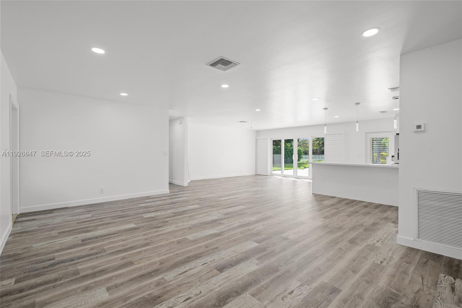 14330 Southwest 16th Street Davie, FL 33325 - Photo 9 of 53 an empty room with wooden floor and windows