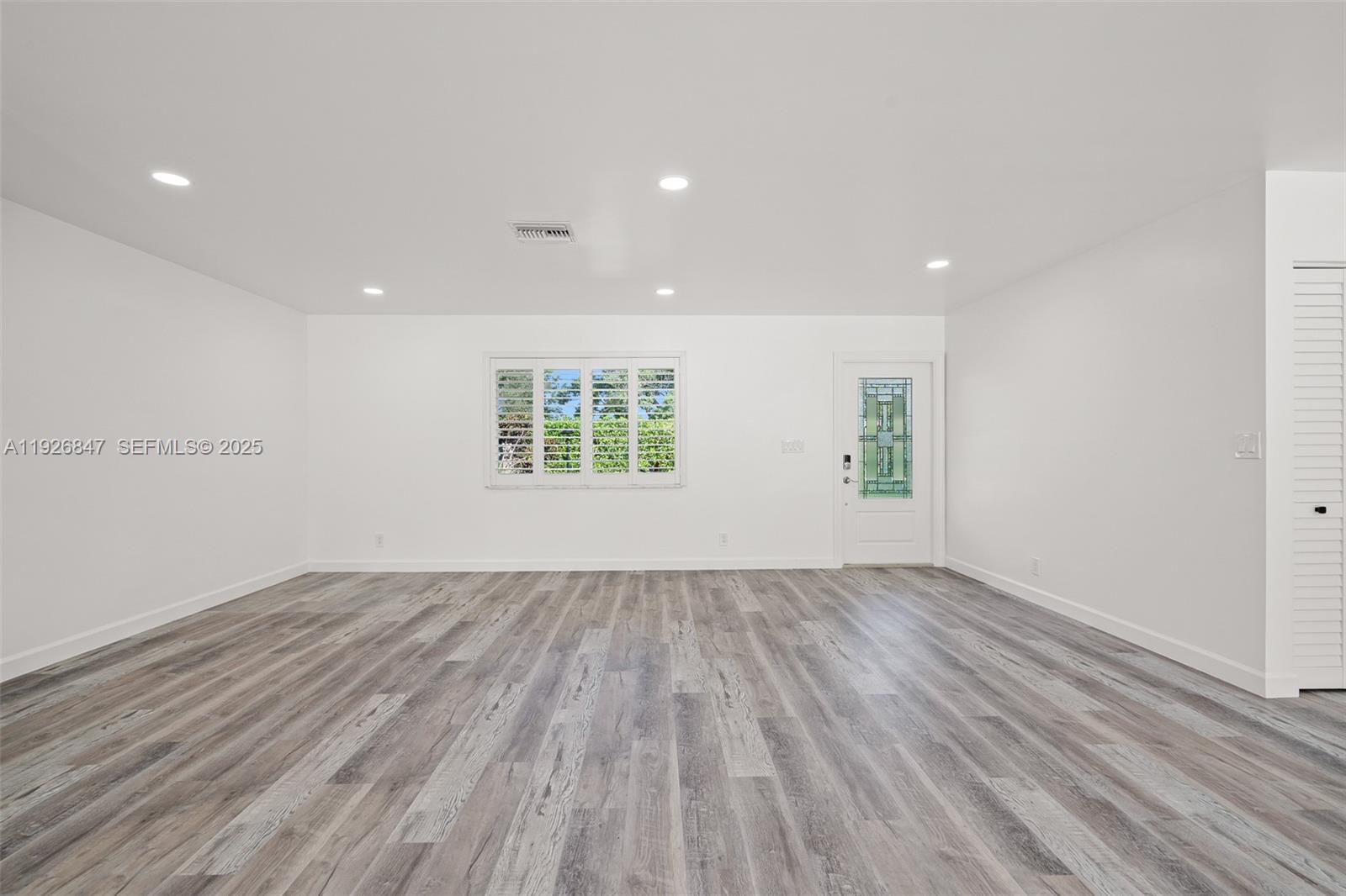 14330 Southwest 16th Street Davie, FL 33325 - Photo 10 of 53 an empty room with wooden floor and windows