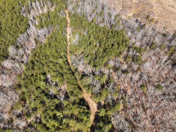 an aerial view of a houses with a yard
