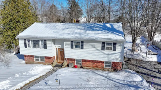 a view of a house with a yard and roof